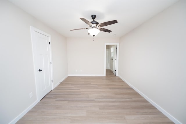 spare room featuring light wood-type flooring and ceiling fan