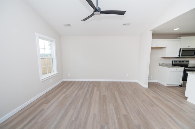 unfurnished living room with ceiling fan, light wood-type flooring, and vaulted ceiling