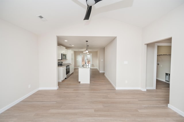 unfurnished living room with vaulted ceiling, ceiling fan, light hardwood / wood-style flooring, and sink