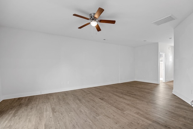 spare room with ceiling fan and dark hardwood / wood-style flooring