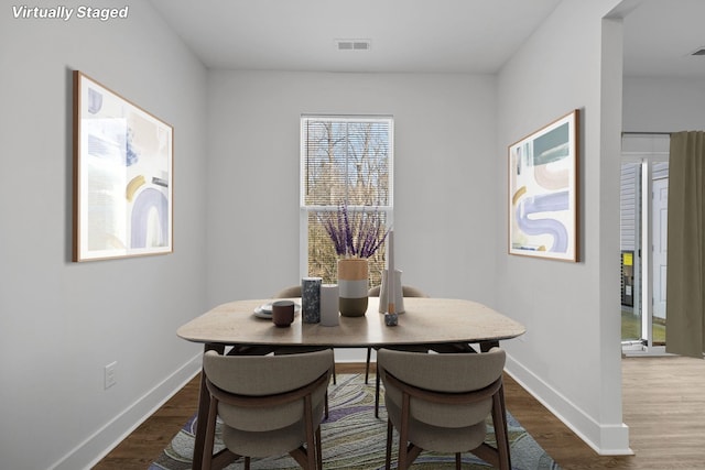 dining room with dark hardwood / wood-style floors