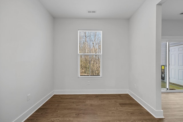 empty room featuring dark hardwood / wood-style flooring