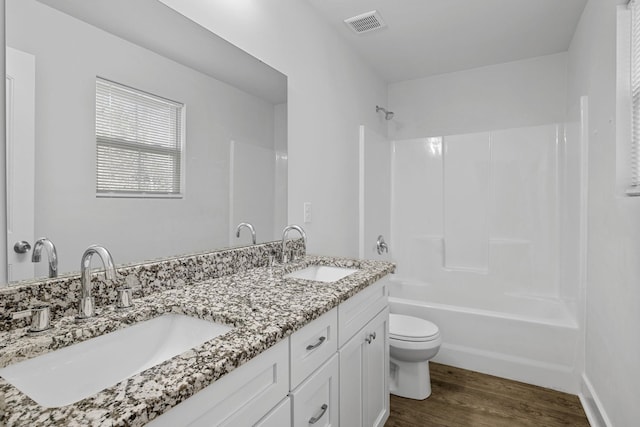 full bathroom featuring toilet, vanity, shower / bathing tub combination, and hardwood / wood-style floors