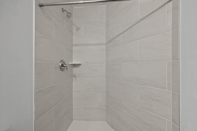 bathroom with tiled shower