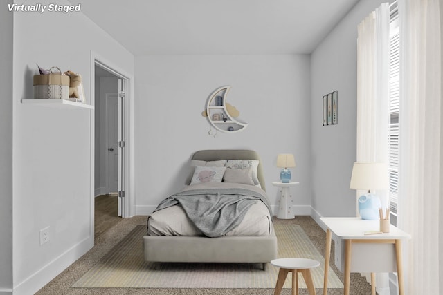 carpeted bedroom featuring multiple windows