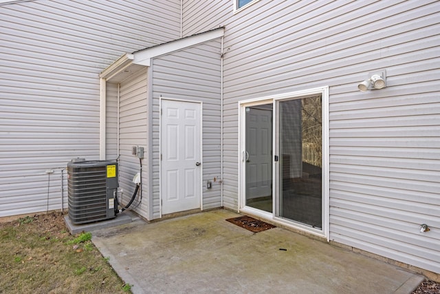 entrance to property with central AC unit and a patio area