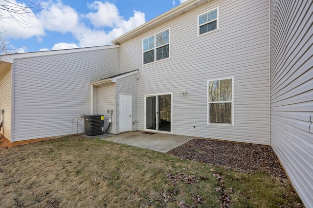 back of house featuring central AC unit, a yard, and a patio