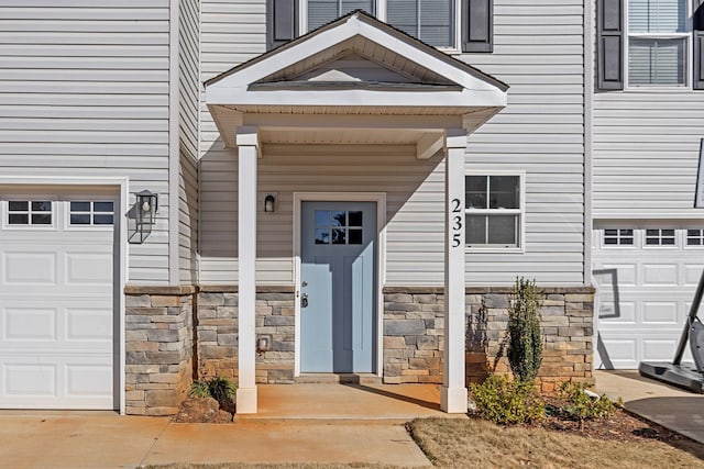 doorway to property with a garage