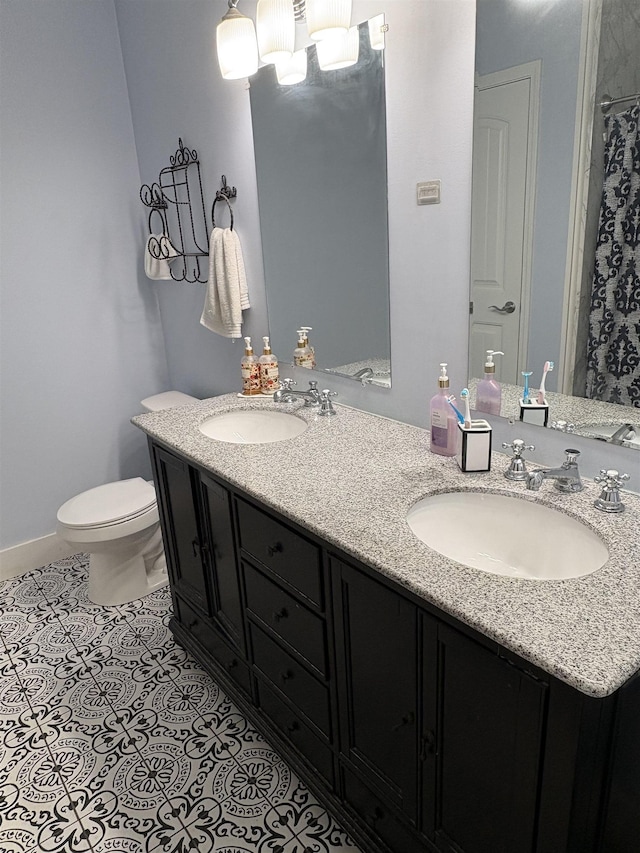 bathroom with toilet, tile patterned flooring, and vanity