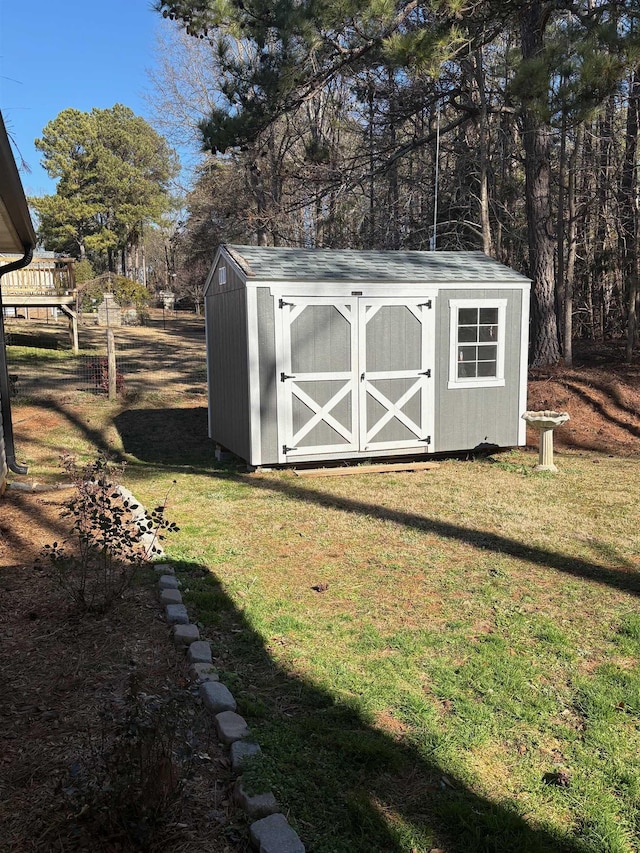 view of outbuilding featuring a yard