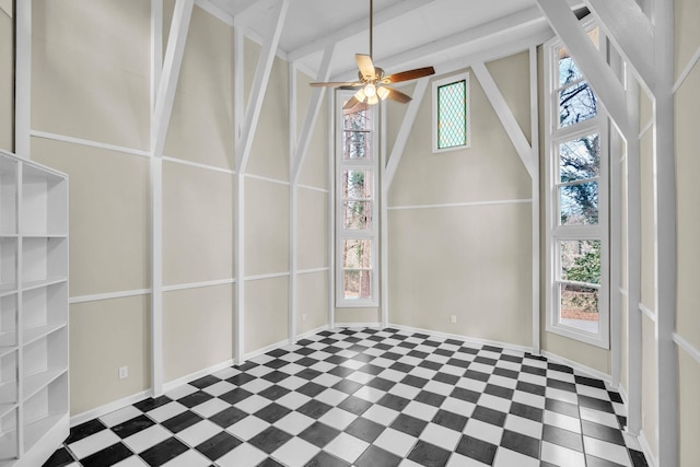 unfurnished sunroom featuring ceiling fan, a healthy amount of sunlight, and lofted ceiling