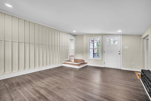 entryway featuring dark wood-type flooring and vaulted ceiling