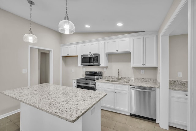 kitchen featuring sink, white cabinetry, appliances with stainless steel finishes, and vaulted ceiling