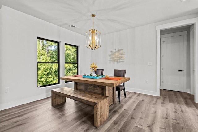 dining room with a wealth of natural light, a chandelier, and hardwood / wood-style floors