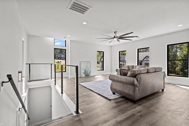 living room featuring ceiling fan and hardwood / wood-style floors