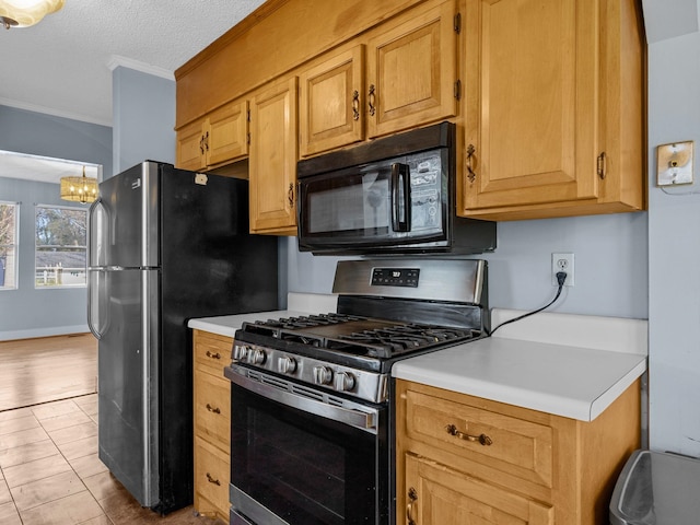 kitchen featuring light tile patterned flooring, a textured ceiling, appliances with stainless steel finishes, and crown molding