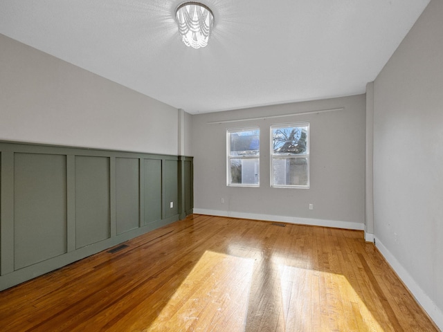 unfurnished room with light wood-type flooring