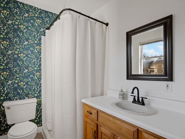 bathroom featuring toilet, vanity, and a textured ceiling