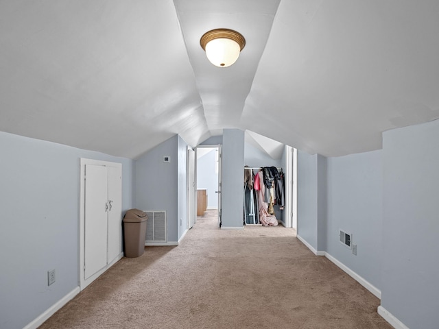 bonus room with light carpet and lofted ceiling