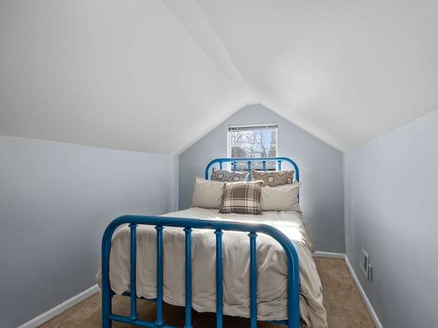 carpeted bedroom with vaulted ceiling