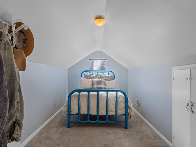 carpeted bedroom featuring lofted ceiling