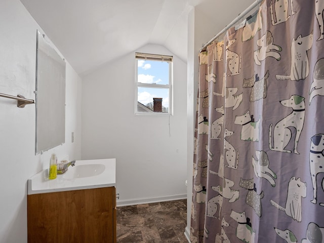 bathroom featuring lofted ceiling and vanity