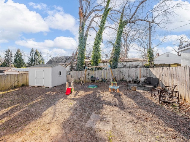 view of yard featuring a playground and a storage shed