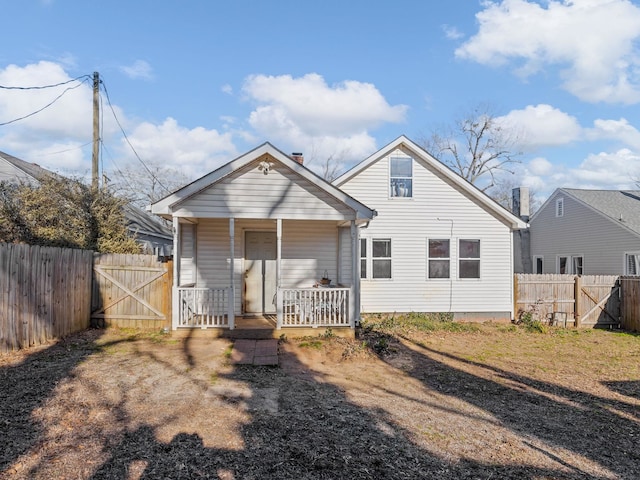 back of house featuring a porch