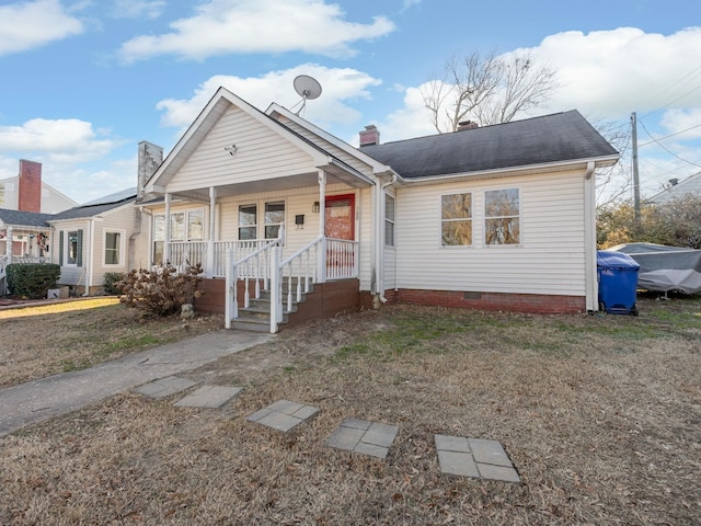 bungalow-style home featuring a front yard and a porch