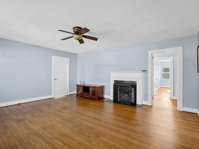 unfurnished living room with a textured ceiling, ceiling fan, and hardwood / wood-style floors