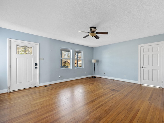 interior space featuring light wood-type flooring, ceiling fan, and a textured ceiling