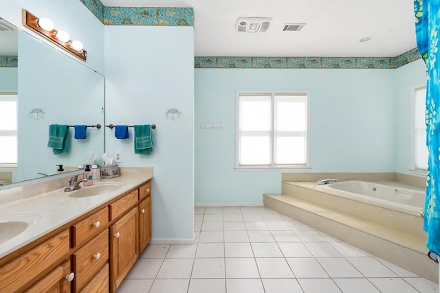 bathroom featuring a tub, tile patterned flooring, and vanity