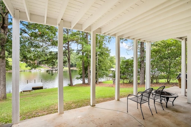 view of patio / terrace featuring a water view and a boat dock