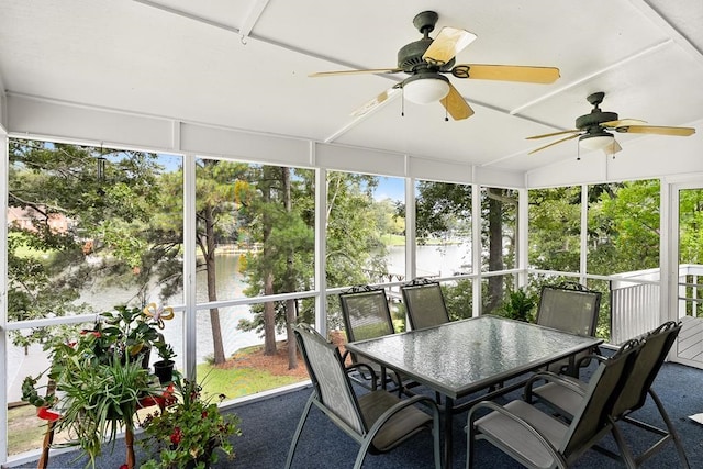 sunroom with a water view, ceiling fan, and a wealth of natural light