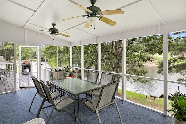 unfurnished sunroom featuring ceiling fan and a wealth of natural light