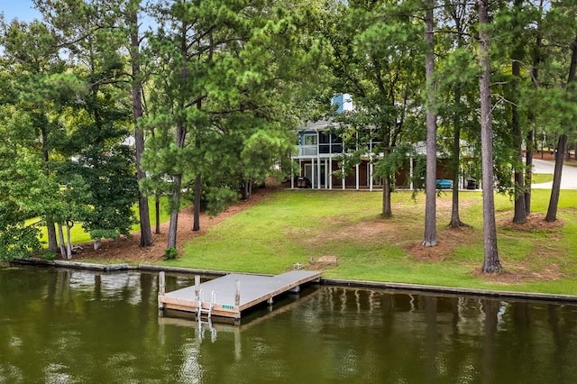 dock area with a water view and a yard