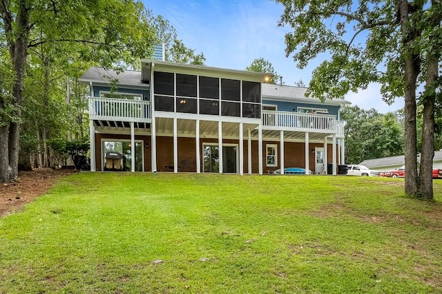 back of house with a yard and a sunroom