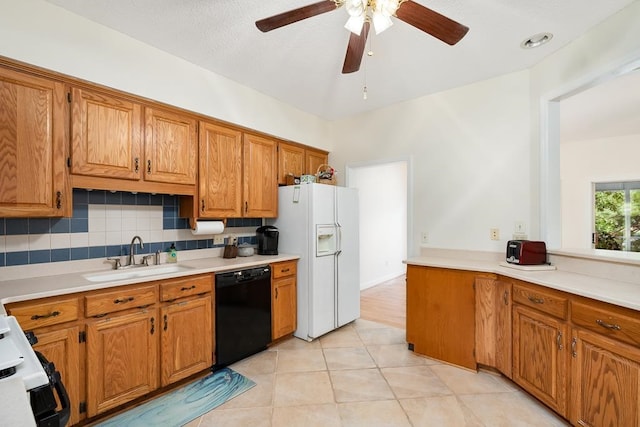 kitchen featuring backsplash, sink, black dishwasher, light tile patterned floors, and white fridge with ice dispenser