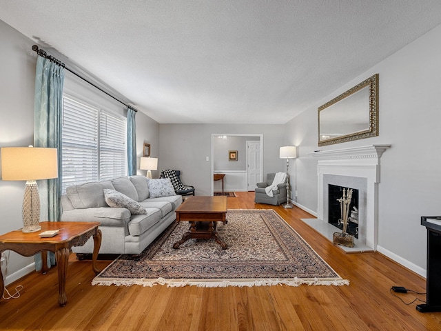 living room with hardwood / wood-style flooring and a textured ceiling