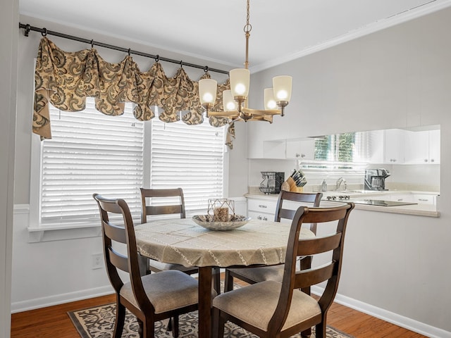 dining space featuring dark wood-type flooring and crown molding