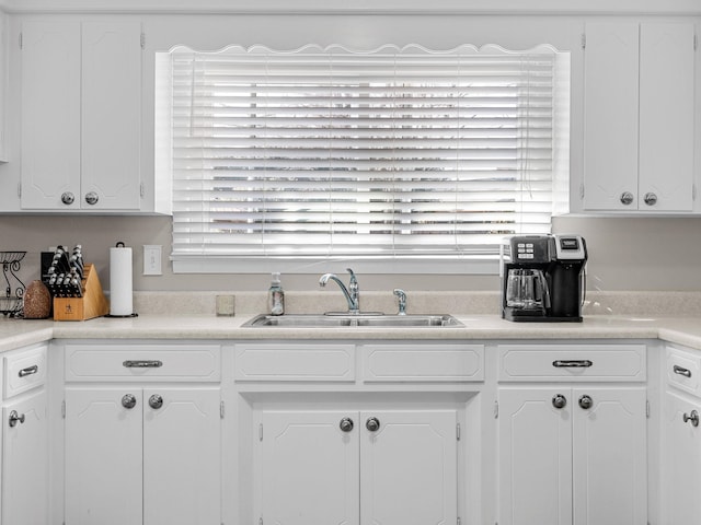 kitchen featuring white cabinetry and sink