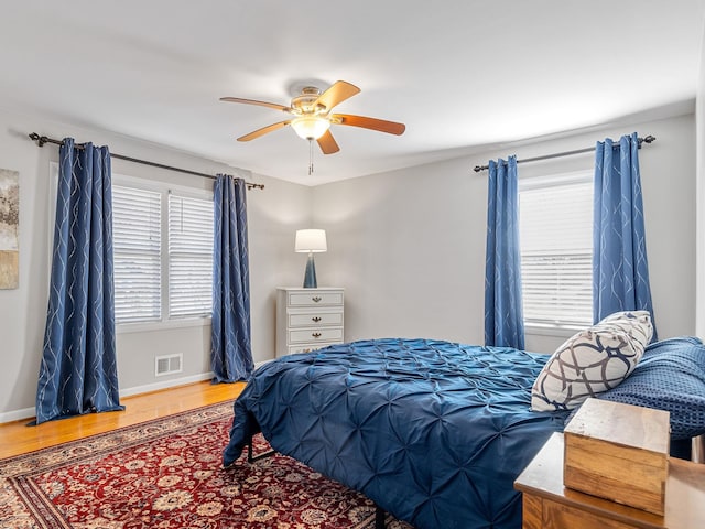 bedroom with ceiling fan and hardwood / wood-style flooring