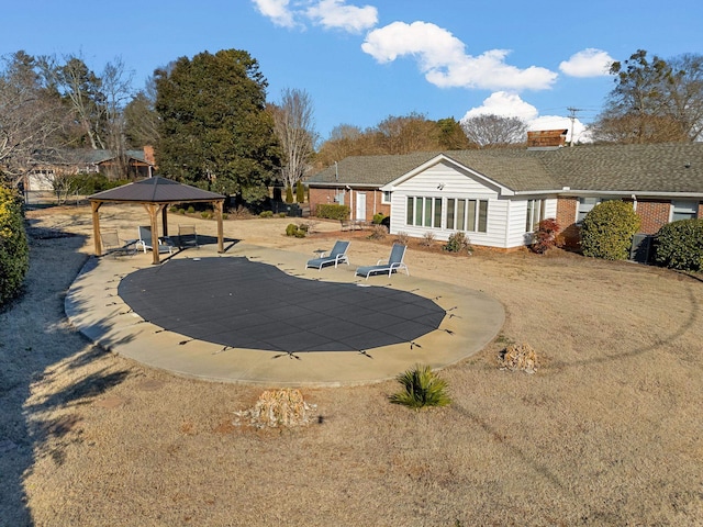 rear view of house with a gazebo and a patio