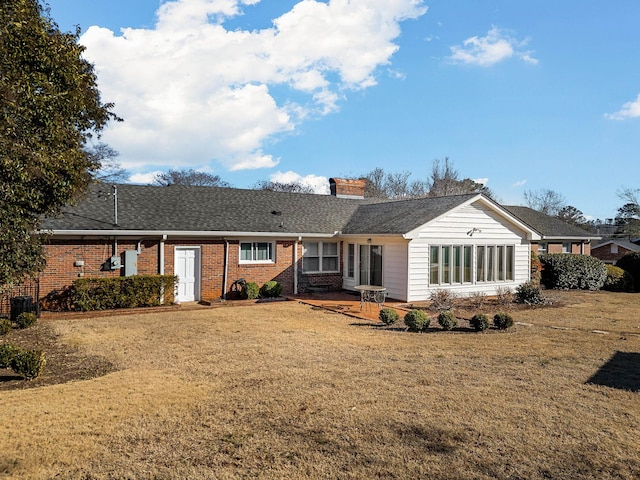 rear view of house with a yard