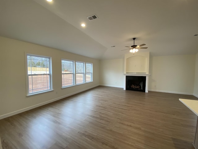 unfurnished living room featuring ceiling fan, lofted ceiling, and dark hardwood / wood-style floors