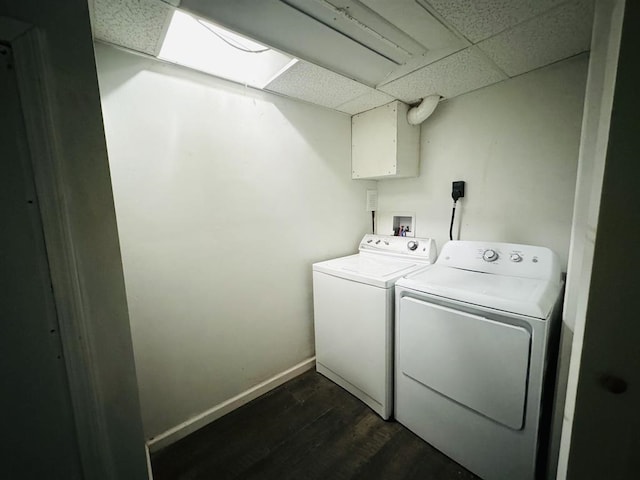 clothes washing area featuring washer and dryer and dark hardwood / wood-style floors