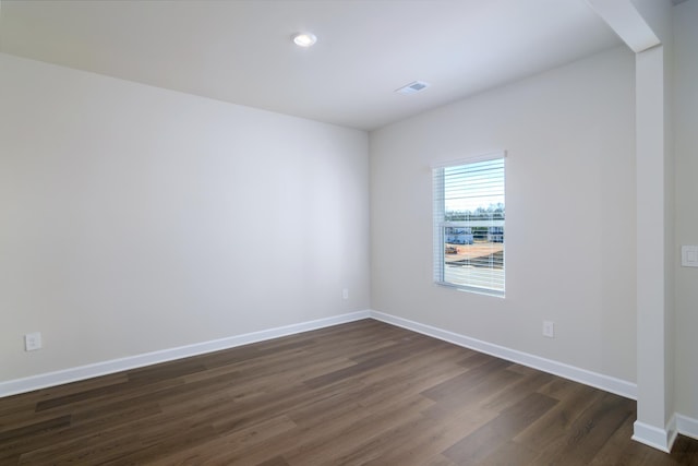 unfurnished room featuring dark wood-type flooring