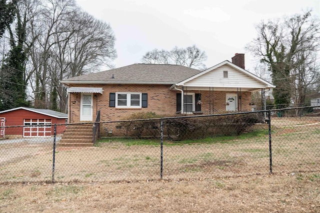 view of front of home featuring a front lawn, an outdoor structure, and a garage