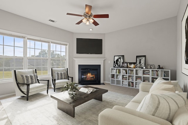 carpeted living room featuring ceiling fan