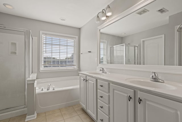 bathroom featuring vanity, tile patterned flooring, and plus walk in shower